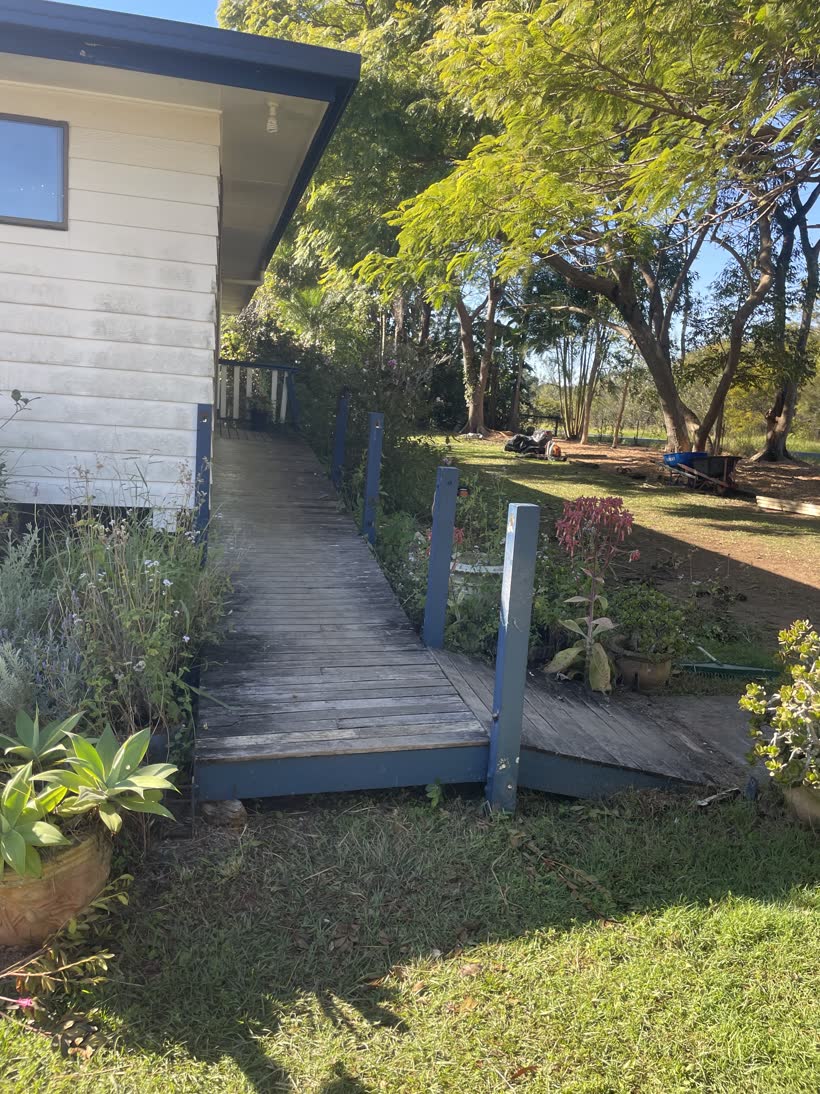Old weathered timber ramp with faded blue posts before rebuilding