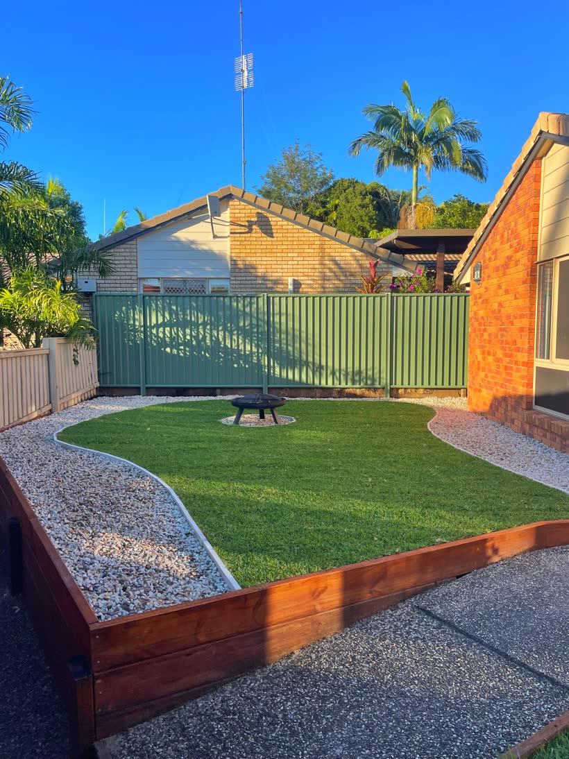 Finished level lawn with new sleeper retaining, pebble borders and a fire pit